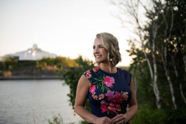 Ashley Larose, standing in front of Science North and Ramsey Lake