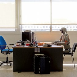 Robot sitting at a desk, part of Vincent Fournier's photography series The Man Machine. (c) 2010 Vincent Fournier