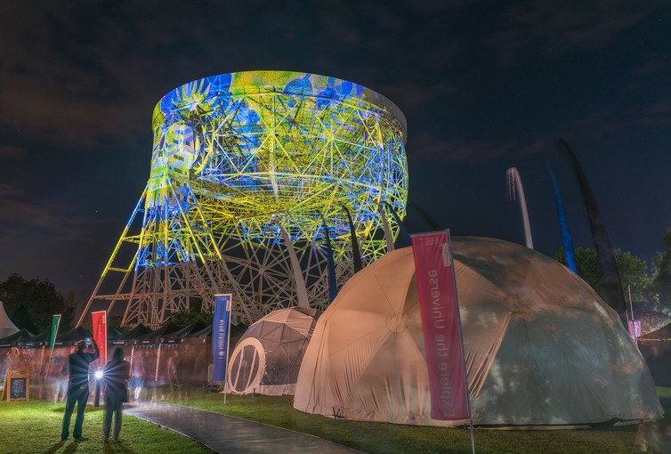 The Lovell radio telescope of Jodrell bank lit up during the Bluedot festival by the Brian Eno art installation project.