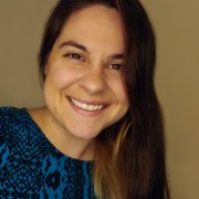 woman with long brown hair and brown eyes smiling