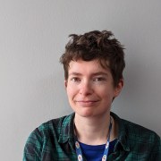 A white woman with short brown hair smiling at the camera