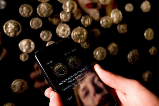 A MONA visitor uses 'The O' at the coin exhibition in the gallery. Photo: Brett Boardman