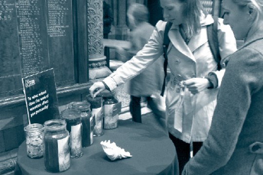 Visitors answer a question  at the Natural History Museum, London, UK