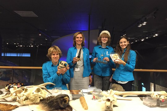 Tom (educator) and Krista (educational developer) pose at their research table, where they investigated asking questions with authentic objects. Two students (on the right) helped with data collection. Naturalis, Leiden, The Netherlands